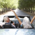 Retirees enjoying a nice drive in their own car