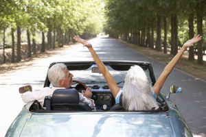 Retirees enjoying a nice drive in their own car